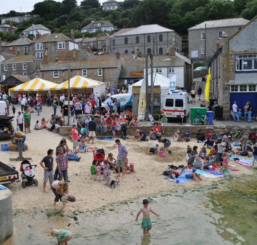 Families enjoying the beach and festival in Mousehole